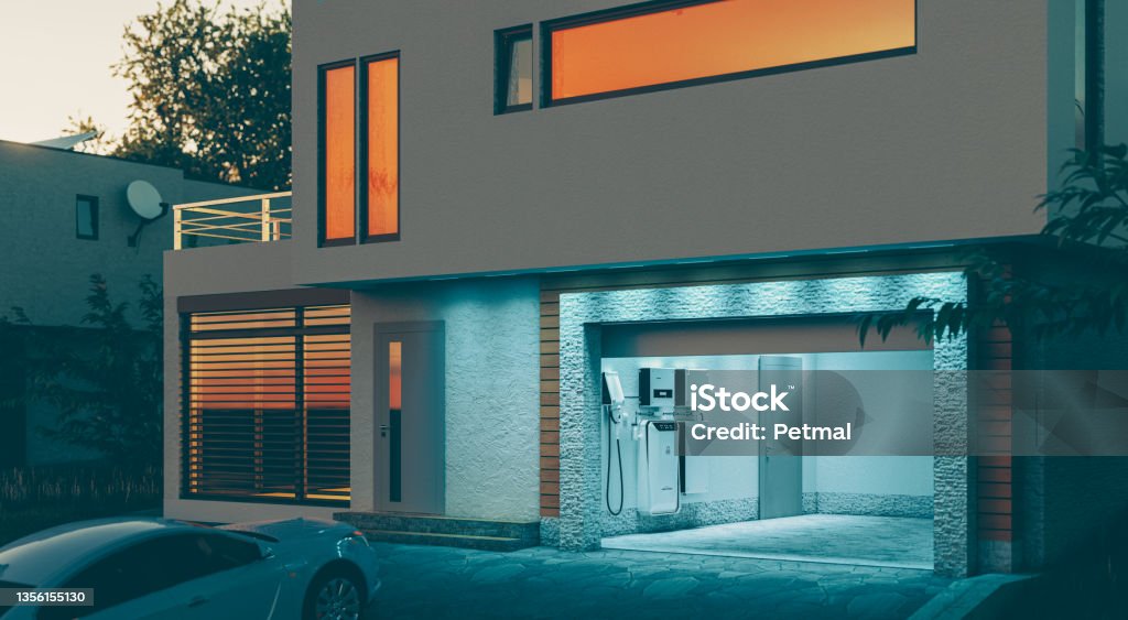 concept of a home battery energy storage system located in the garage of a modern family house in a futuristic blue light illuminating the evening atmosphere of a quiet street. 3d rendering.